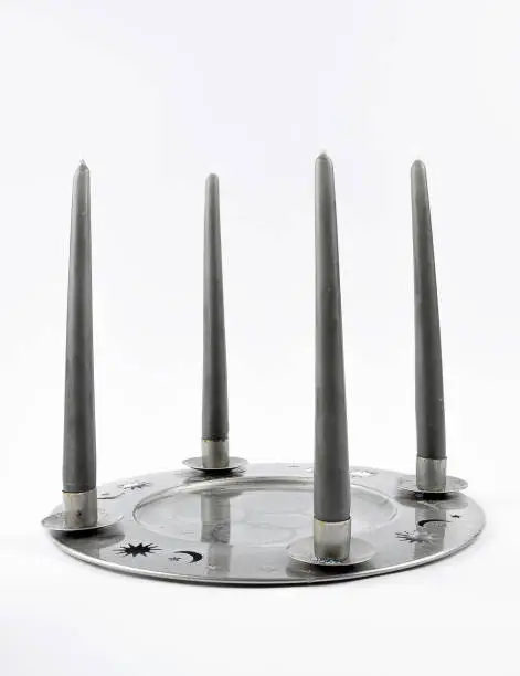 Tin plate as a candleholders on a gray background