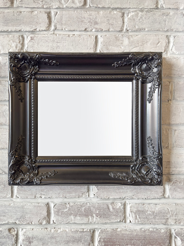 Blank picture frame on a brick wall