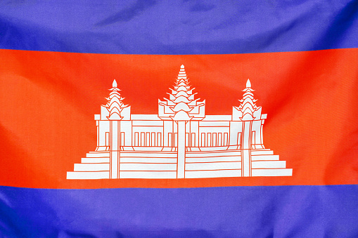 Fabric texture flag of Cambodia. Flag of Cambodia waving in the wind. Cambodia flag is depicted on a sports cloth fabric with many folds. Sport team banner.