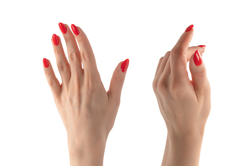 Closeup of female hand with pale skin and red nails pointing or touching isolated on a white background.