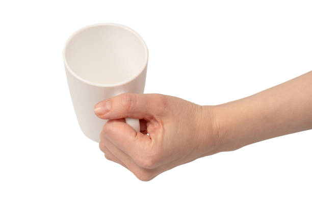 istock Female hand is holding tea cup isolated on a white background. 1925046218