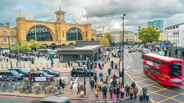 Time lapse top view of Crowd traffic and commuter tourist people walking and crossing road at London King's Cross railway station in Central London, United Kingdom