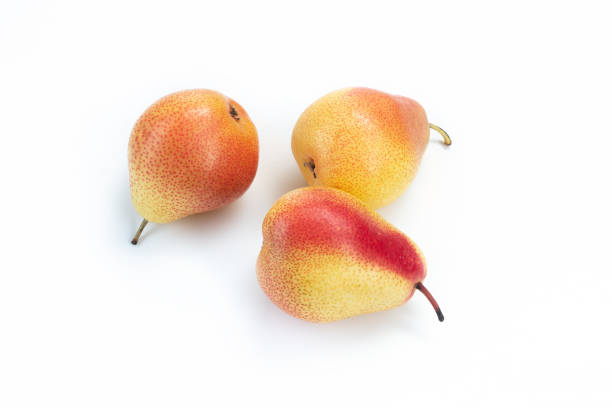 Three pears edible fruits, tasty ripened red yellow fruit still life on wooden background