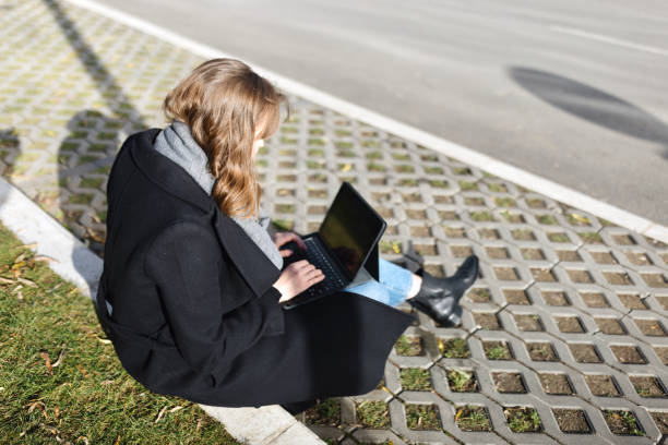 istock Modern woman working remotely outdoors 1925059363