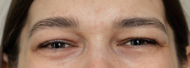 the upper part of the girl's face. women's eyes close-up. - eyes narrowed imagens e fotografias de stock