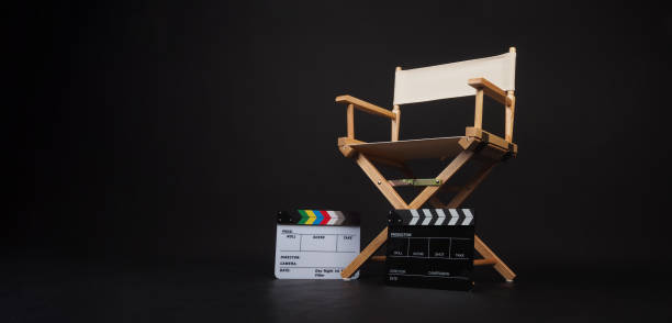 istock Two clapper board with white director chair on black background. 1925088315