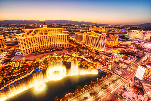 Las Vegas, Nevada, USA - July 5th, 2022: Beautifully illuminated buildings of the Bellagio and reflected in the water at night