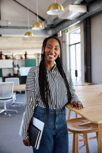 istock Young businesswoman smiling while standing by an office table 1925089797