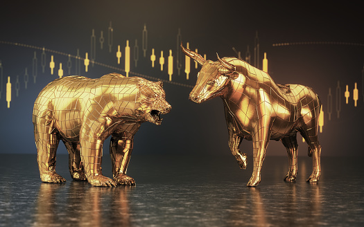 A closeup of two metal castings depicting a stylized bull alongside a bear in dramatic light representing  financial market trends on an isolated dark background - 3D render