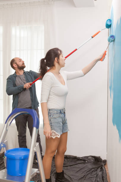 istock Husband and wife decorating the flat 1925111608