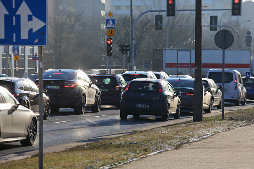 Warsaw, Poland - January 9, 2024: Traffic jam at the junction. Traffic is stopped at a red light indicated by a traffic signal. Other traffic signs are visible. Streets in Goclaw housing estate