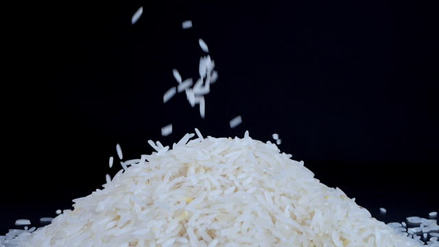 Basmati white rice falling on a black background