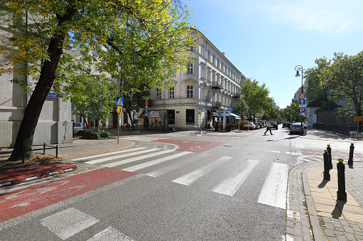 Warsaw, Poland - September 20, 2023: The building at the crossroads in the city centre. There is almost no traffic here now, and the pedestrian crossings are almost empty.