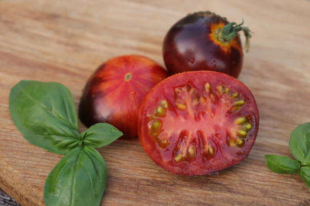 istock beautiful varietal ripe tomato closeup on a wooden surface 1925148862