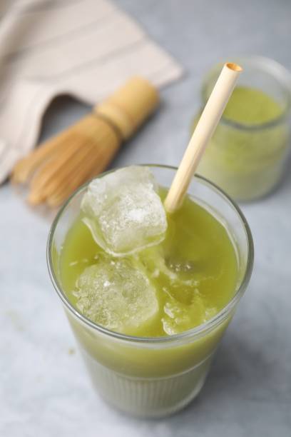 istock Glass of delicious iced green matcha tea on light grey table, above view 1925164199