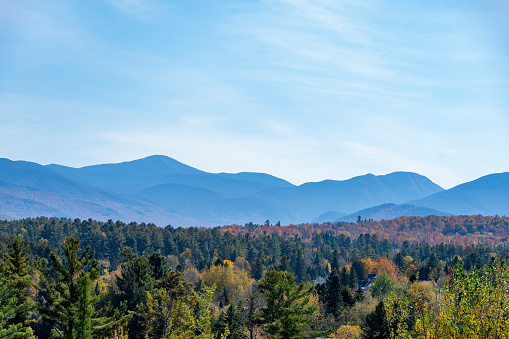 View at sunset over the autumnal leaf coloured forests near Mirror Lake, Lake Placid.