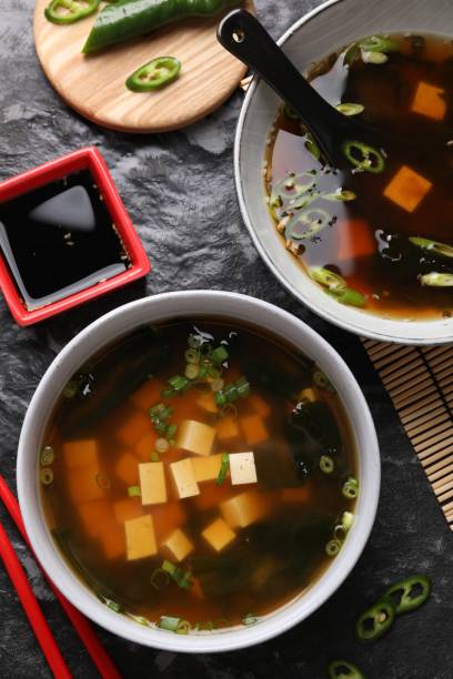 istock Delicious miso soup with tofu served on black textured table, flat lay 1925184745