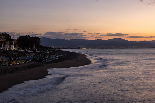View of Bajondillo beach in Torremolinos just before sunrise. Costa del Sol, Spain