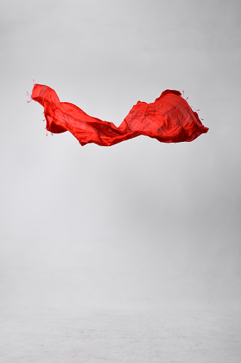 Red scarf flying in the air.