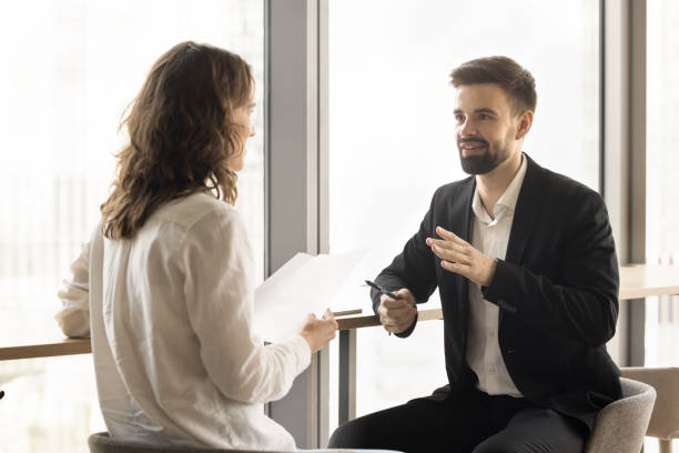 istock Positive young professional coworkers discussing project reports 1925220390