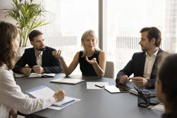 istock Confident middle aged mentor woman training company staff 1925236111