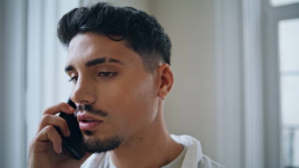 istock Worried businessman calling smartphone at home portrait. Serious guy talking 1925257430