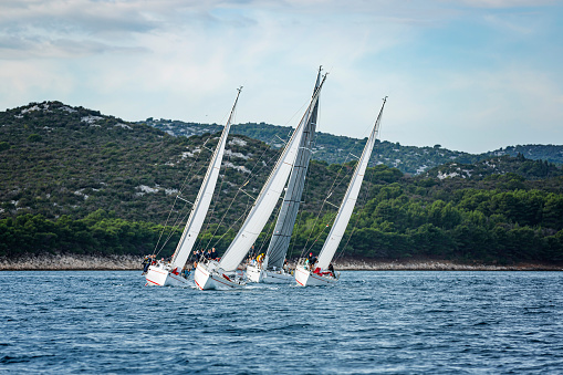 Several sailing crews on sailboats on regatta in action. Event regatta property released.