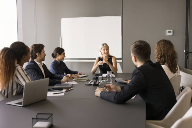 istock Confident middle aged team leader woman meeting with diverse group 1925258519