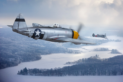 A P-47 Thunderbolt chases a Focke-Wulf 190 (models) over a winter landscape