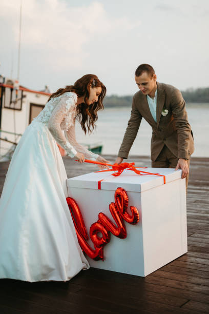 bride and groom opening a wedding gift