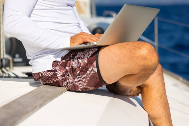istock Businessman with laptop on sailboat 1925269054