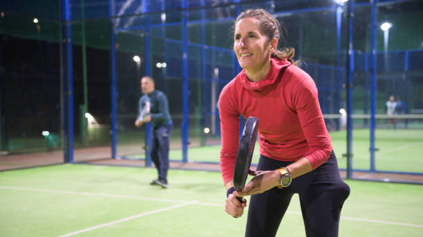 padel tennis player ready to serve - mixed age stock-fotos und bilder