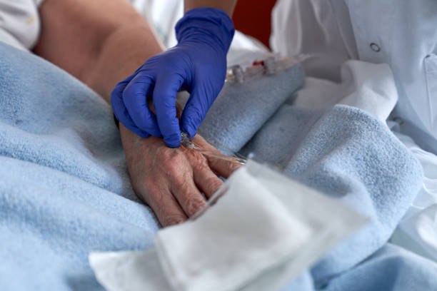 istock Unrecognizable doctor attaching catheter on hand of patient 1925283797