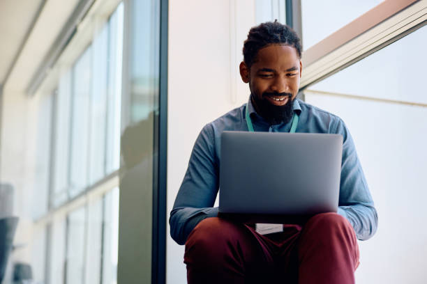 istock Happy black entrepreneur working on laptop by the window in the office. 1925292203