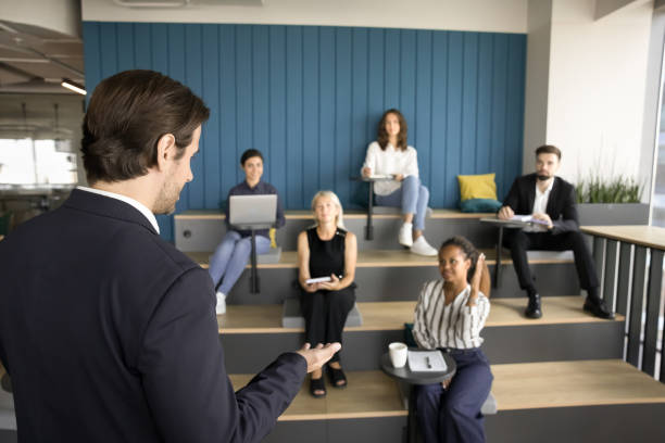 istock Business teacher, presenter man taking questions from small audience 1925303406