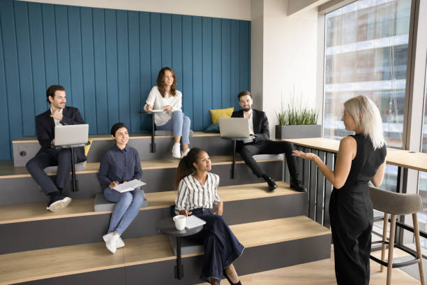 Confident mature business teacher training diverse business students