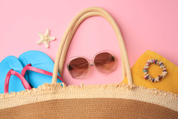 istock Bag with beach accessories on pink background, flat lay 1925316444