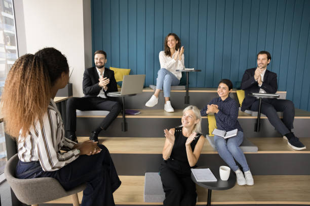 istock Diverse group applauding young African American presenter woman 1925322958
