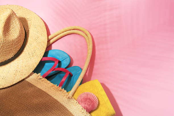 istock Bag with beach accessories on pink background, above view. Space for text 1925325648