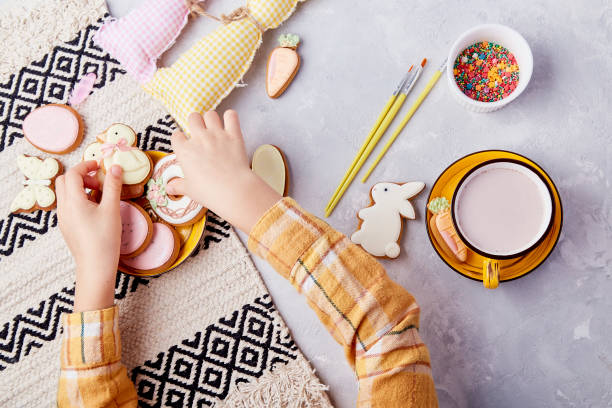 istock Happy kid with easter treats. Tradition cookies decoration by kid flat lay 1925326714
