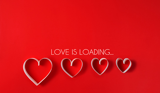 Loading process with hearts for Valentine’s Day concept on a red background