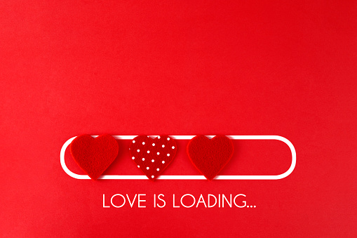 Loading process with hearts for Valentine’s Day concept on a red background