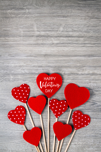 Happy Valentine’s day concept with felt hearts on wooden backgorund