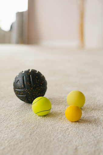 Balls and pads for myofascial relaxation and self-massage at home on the floor. MFR, fitness and Pilates.