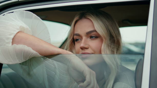 istock Model posing automobile window looking outside close up. Woman sitting retro car 1925376519