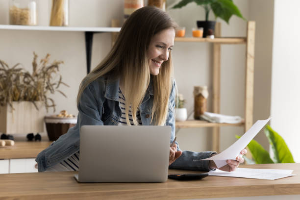 istock Cheerful satisfied accountant woman working at home workplace 1925406624