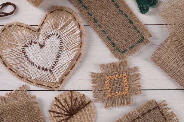 istock Flat lay composition with pieces of burlap fabric on white wooden table 1925413521