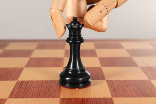 Black wooden chess king isolated on white background