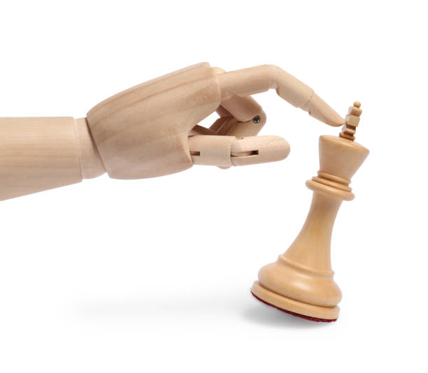 istock Robot touching chess piece isolated on white. Wooden hand representing artificial intelligence 1925418404