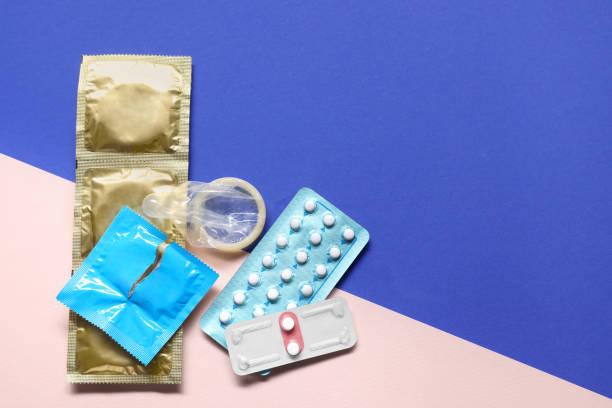 콘돔과 피임약은 컬러 배경, 평평한 위치 및 텍스트를 위한 공간입니다. 피임 방법 선택 - condom sex sexually transmitted disease aids 뉴스 사진 이미지